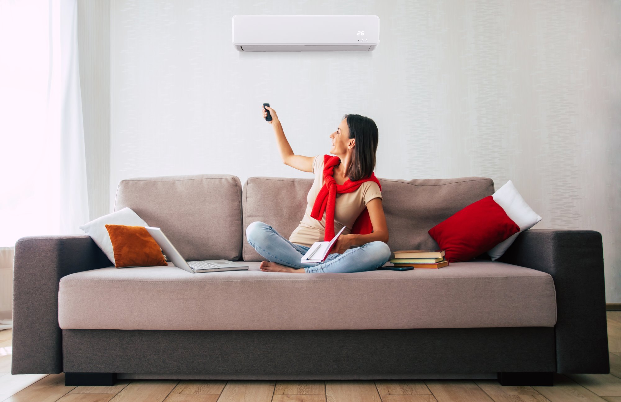 beautiful-modern-brunette-woman-is-using-air-conditioner-while-sitting-couch-resting-hot-day.jpg