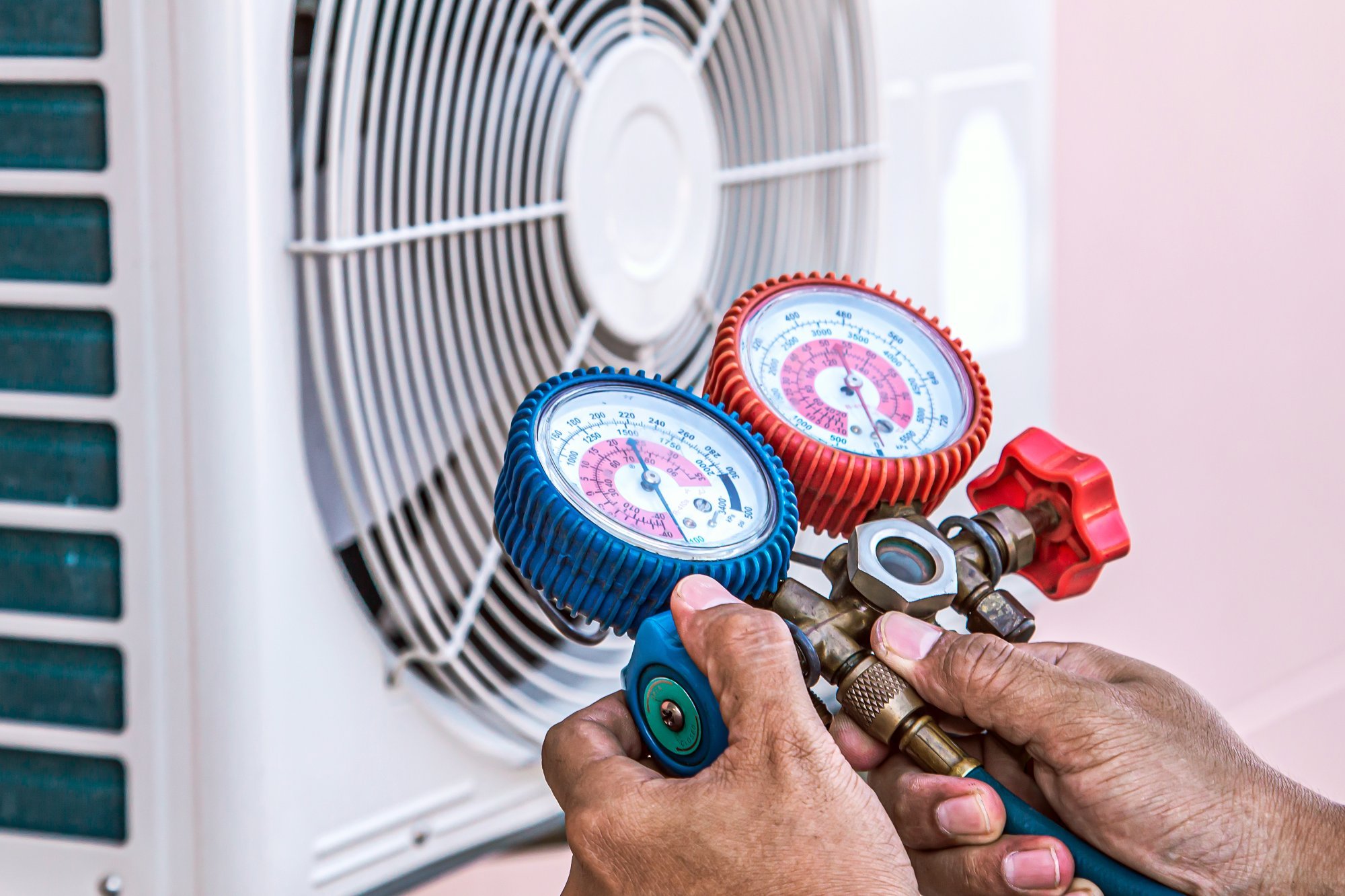 close-up-hand-technician-using-manifold-gauge-filling-air-conditioners.jpg