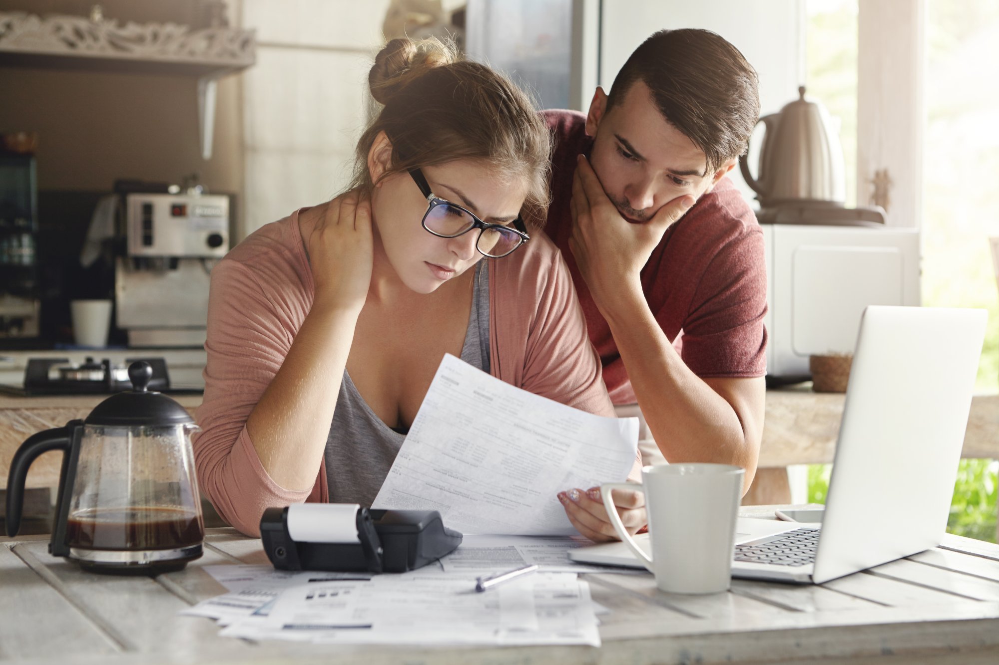 young-caucasian-family-having-debt-problems-able-pay-out-their-loan-female-glasses-brunette-man-studying-paper-form-bank-while-managing-domestic-budget-together-kitchen-interior.jpg